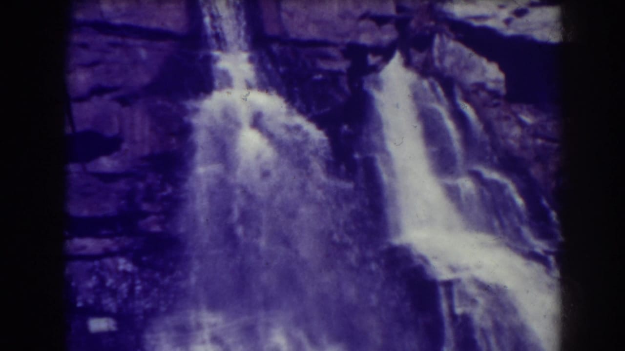 A closer 1938 view of Blackwater Falls shows bright water dropping across dark cliff shelves with visible grain and purple tint.
