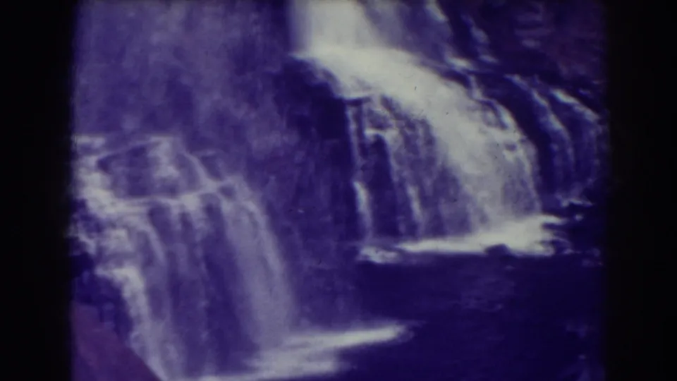 The final frame holds on Blackwater Falls as streams of water pass over multiple ledges into a darker lower section of the scene.