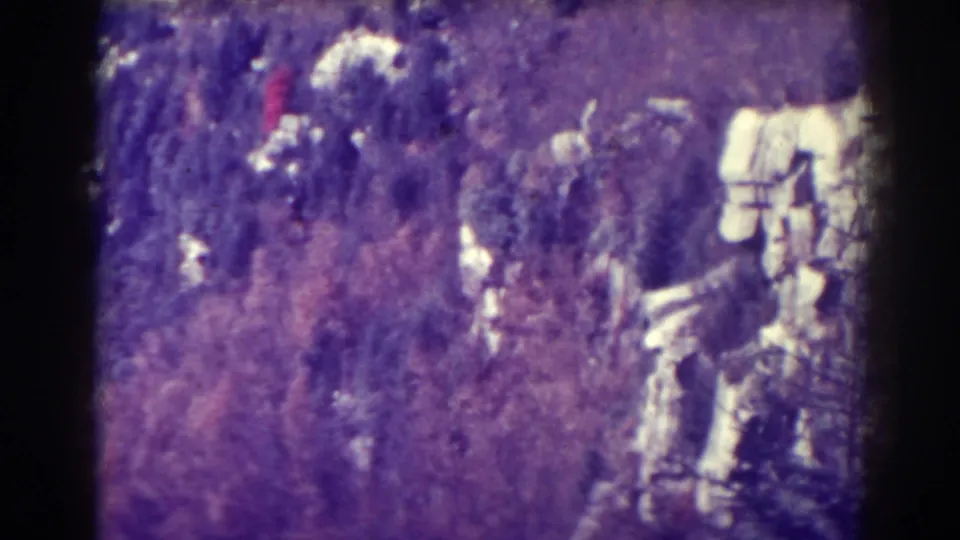 Soft 1938 home-movie frame of a rugged Blackwater Falls hillside, showing brush, rocky outcrops, and pale stone or snow patches.