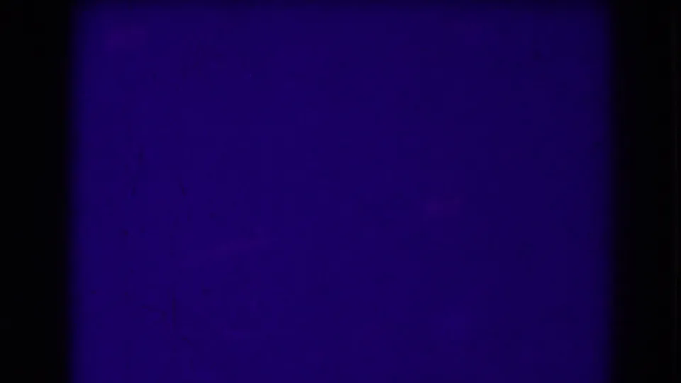 The final 8mm frame is dominated by dark blue-purple exposure, with only faint landscape traces and surface wear visible.