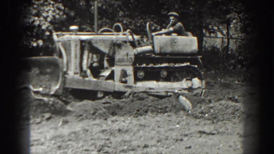 In the final frame, the Cumberland bulldozer continues across the clearing, with its tracks, blade, operator, and churned earth visible.