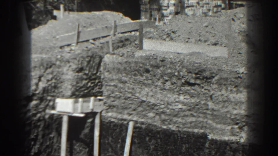 The final 1938 Cumberland frame shows the dirt road, simple barrier, and a faint figure near the upper edge of the work area.