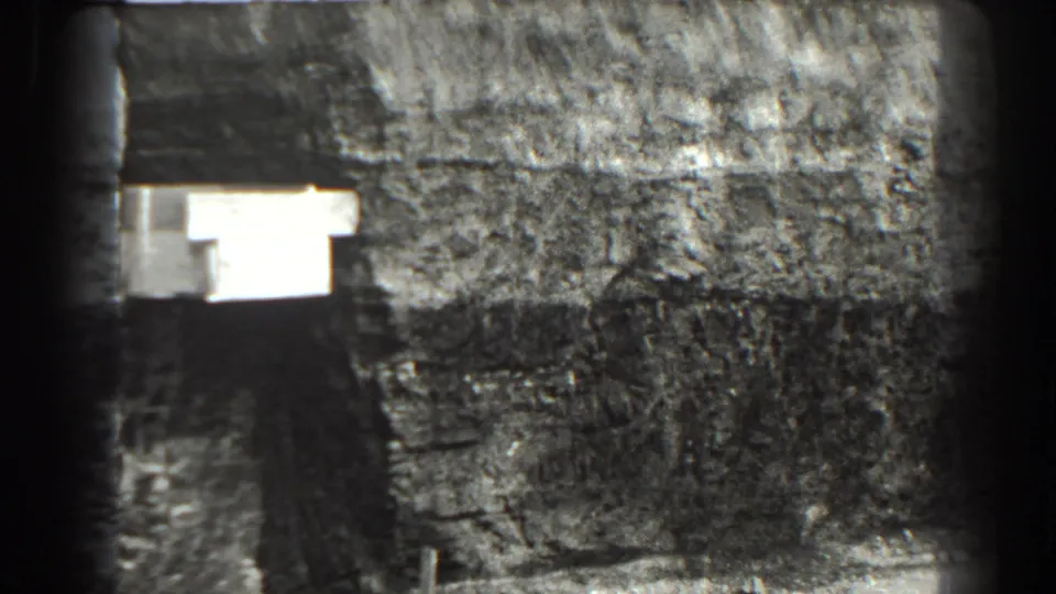 1938 Cumberland, Maryland 8mm frame showing a blurred close view of the excavation area and a bright rectangular foreground object.