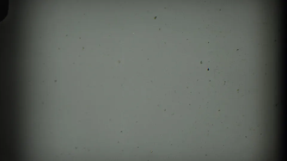 Blank 1938 8mm home-movie frame from the Cumberland reel with pale exposure, grain, dust specks, and dark edge falloff.