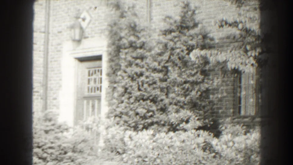 The final frame shows the Cumberland house facade from farther along the pan, with ivy, a doorway, a window, and layered garden planting.