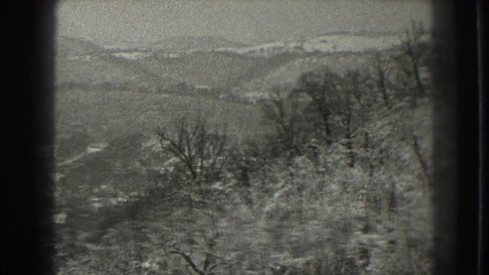 The final frame shows snowy Martinsburg hills beyond leafless trees in grainy 1938 8mm footage.