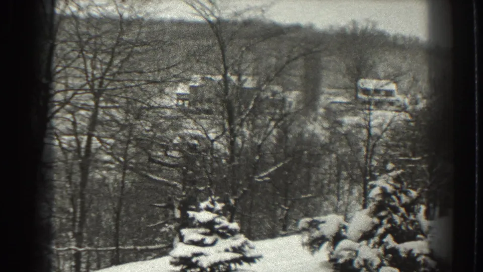 The pan continues across a snowy Martinsburg hillside with leafless trees, evergreens, and distant farm structures.