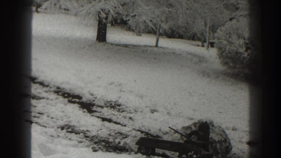 Final 1938 Martinsburg frame showing a quiet snow-covered outdoor area, bare trees, and an indistinct object near the lower right.