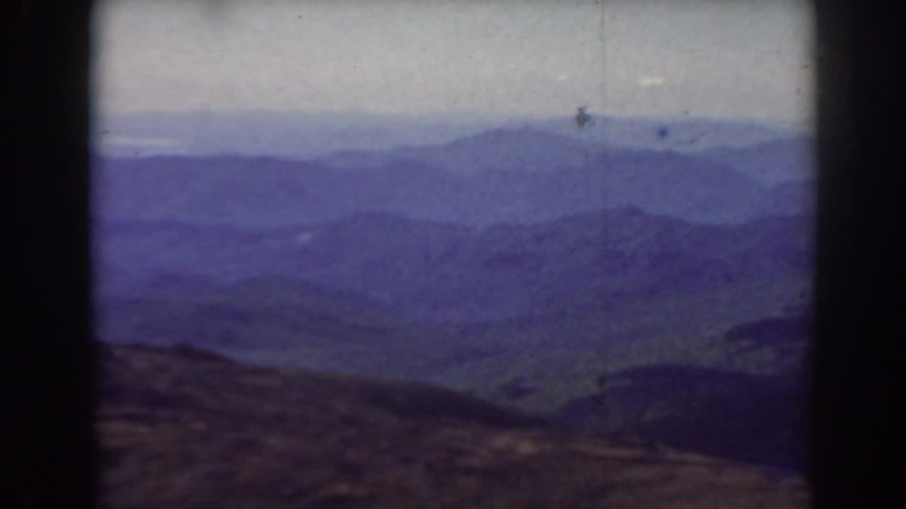Distant mountain range and valley haze seen through a rounded 8mm frame.