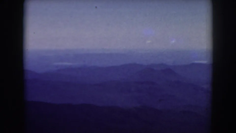 Mount Washington 1938 8mm view of distant New Hampshire ridges fading into blue haze below an overcast sky.