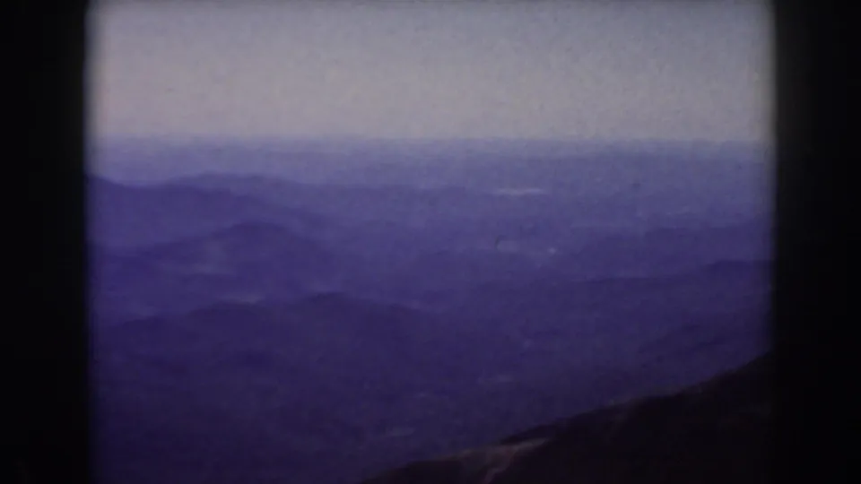 Late-frame view of the 1938 Mount Washington mountain panorama, with hazy hills and a dark foreground edge.