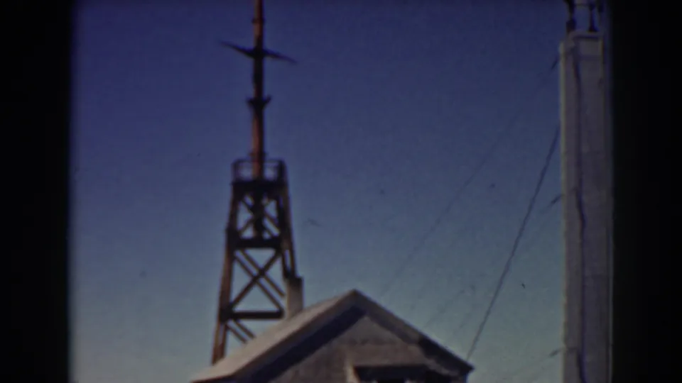 The final frame shows the tower and roofline of the Mount Washington rail-side building, with a pole at right and clear sky behind.