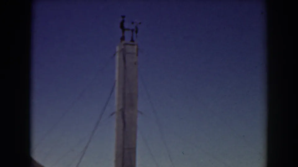 Mount Washington tower top with wind-vane hardware visible in faded 8mm color.