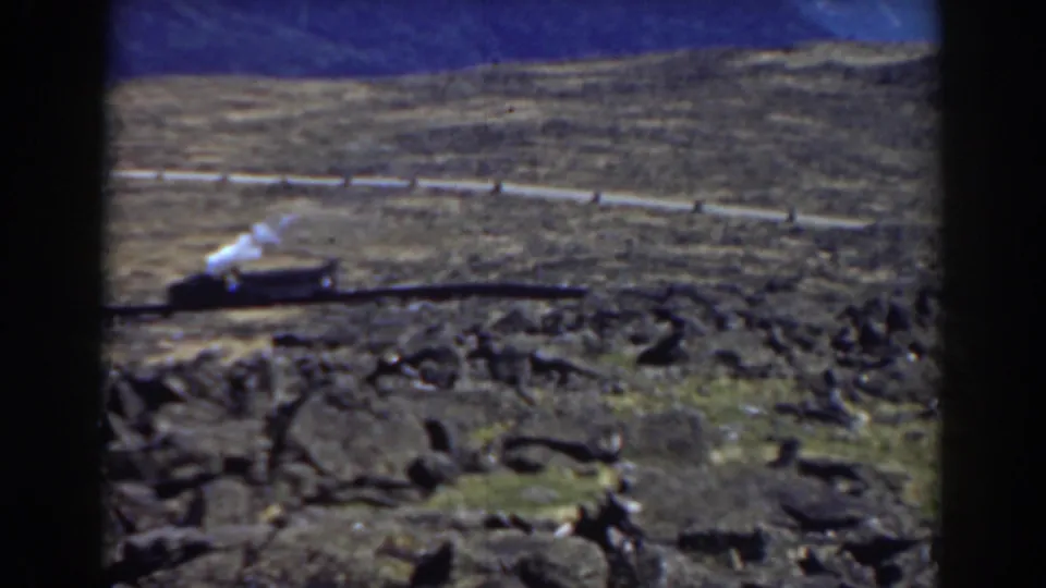Mount Washington 8mm frame from 1938 showing a steam train crossing the rocky slope with visible film gate edges.