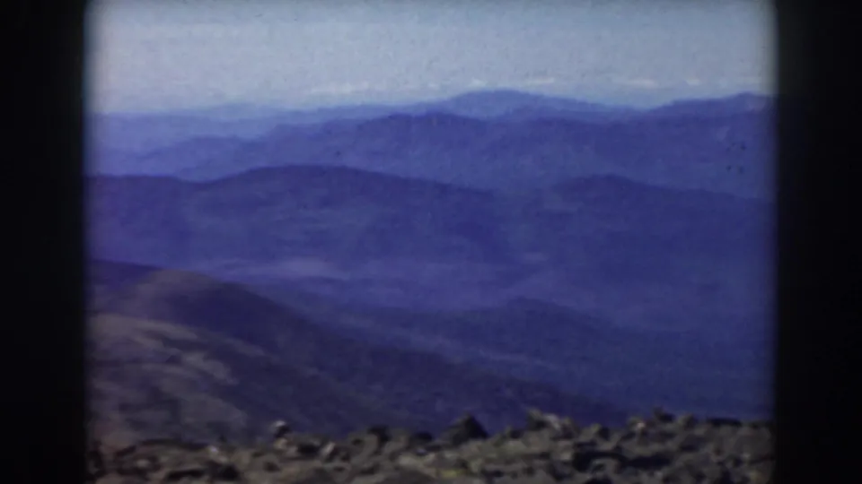 Mount Washington, New Hampshire view in 1938 home-movie footage, with hazy mountain ridges and rocky terrain in the foreground.