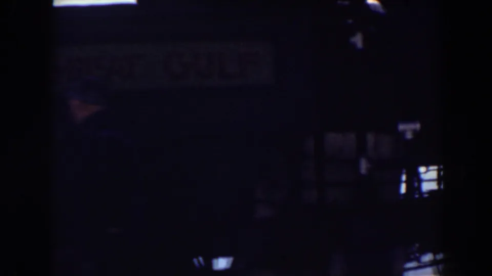 Underexposed 1938 Mount Washington rail footage with the train structure mostly in shadow and small highlights visible.