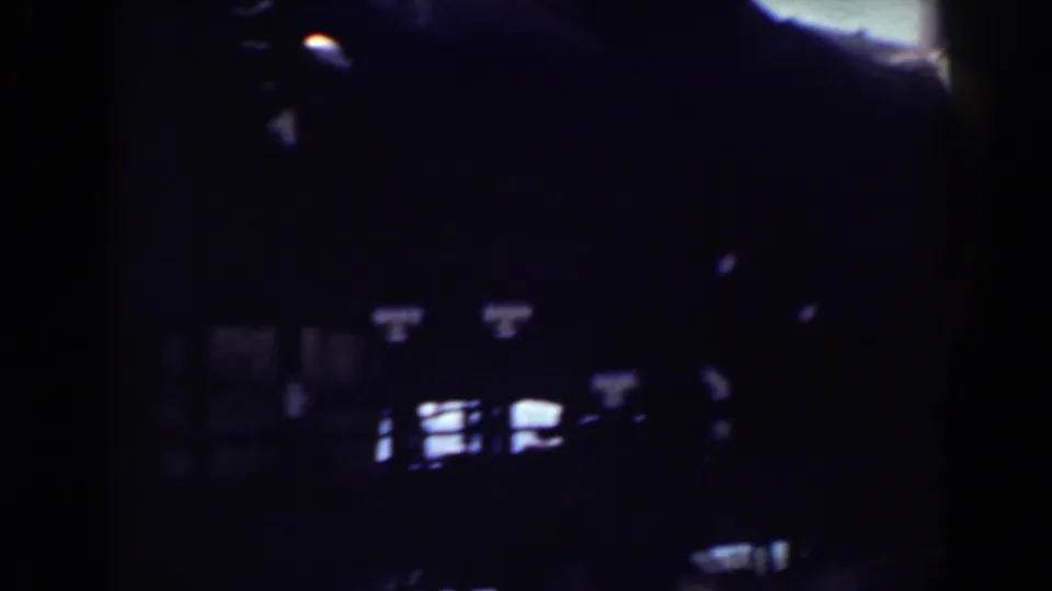 Shadow-heavy Mount Washington rail frame from 1938, showing dark train forms and small bright openings along the lower edge.