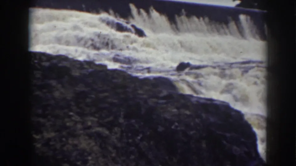 1938 8mm view near Mount Washington showing turbulent white water moving around dark rocks below a spillway-like ledge.