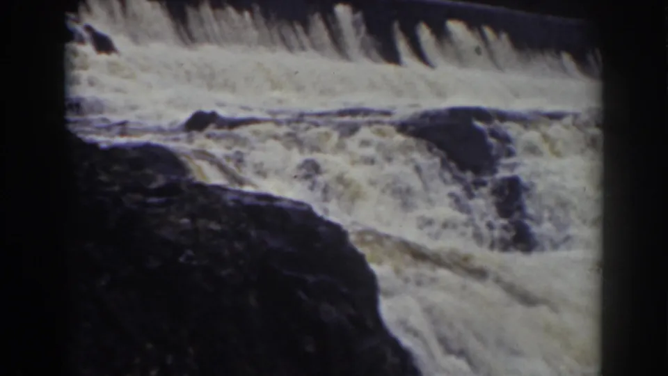 1938 8mm view of rushing water and dark rocks at a Mount Washington, New Hampshire waterfall.