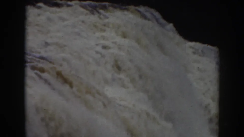 Close 1938 8mm view of turbulent white water at Crystal Cascade near Mount Washington, with dark frame edges and soft grain.