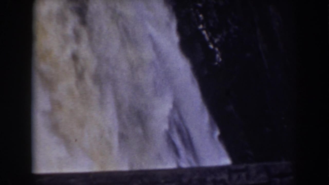 1938 8mm view near Mount Washington showing a waterfall plunging past dark rock into mist.