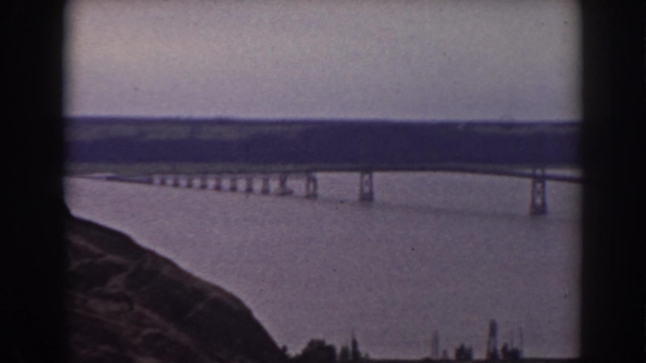 1938 8mm frame showing a bridge over water from a rocky overlook in the supplied Mount Washington, New Hampshire travel footage.