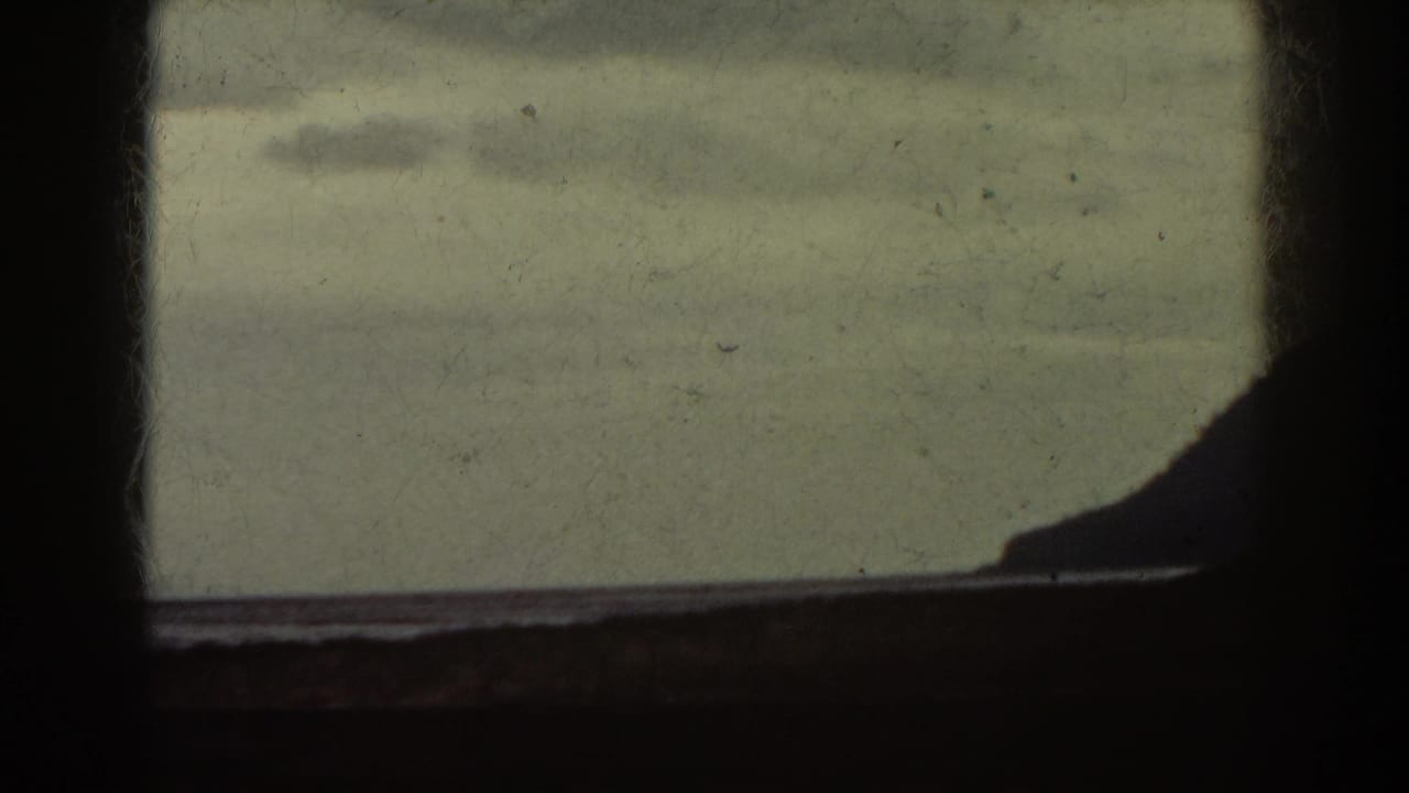 Window grid with a dim shoreline or ridge shape at the right edge.