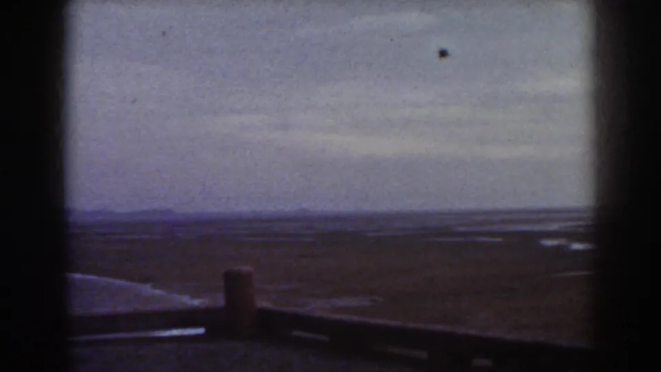 Late-1930s Mount Washington winter landscape with a dark foreground post and railing against a soft, blue-gray snowy distance.