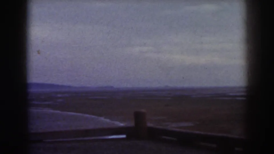 1938 Mount Washington home-movie frame showing an open plain and distant ridgeline seen through a dark window-like border.