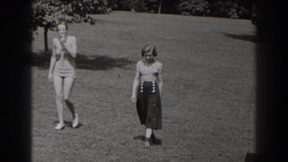 Near the end of the 1938 New Jersey clip, two women walk close to the camera across a lawn, with 8mm frame edges visible.