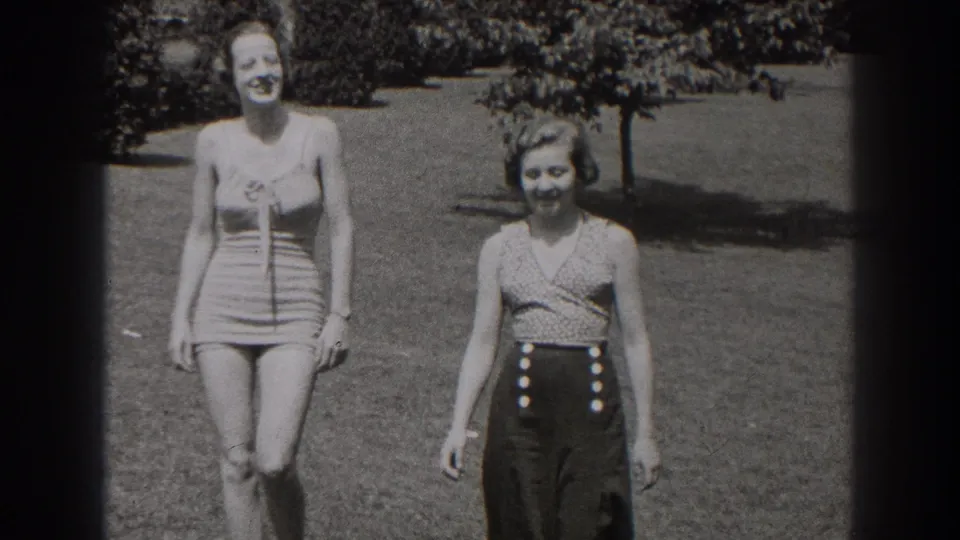 The women approach the camera in a 1938 New Jersey field, their summer clothing and relaxed expressions clear in the 8mm frame.