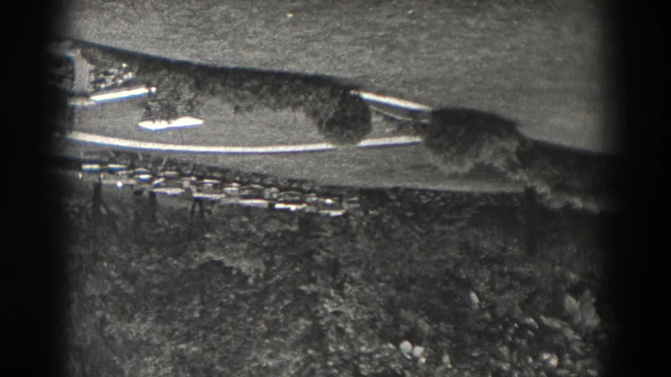1938 New Jersey 8mm frame showing an upside-down elevated view over a park path, grass, and dense tree cover.