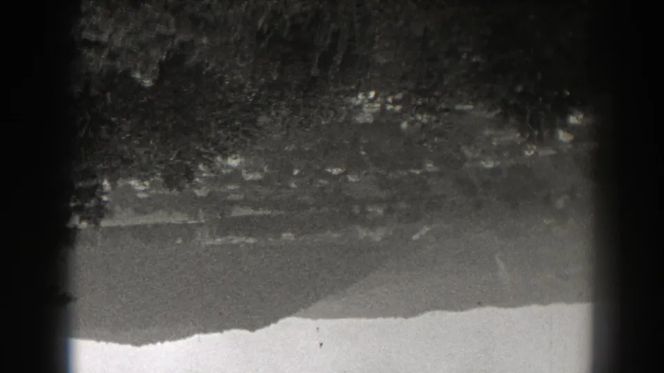 Black-and-white 1938 New Jersey lake view with soft tree reflections, a bright shoreline band, and visible 8mm gate shadowing.