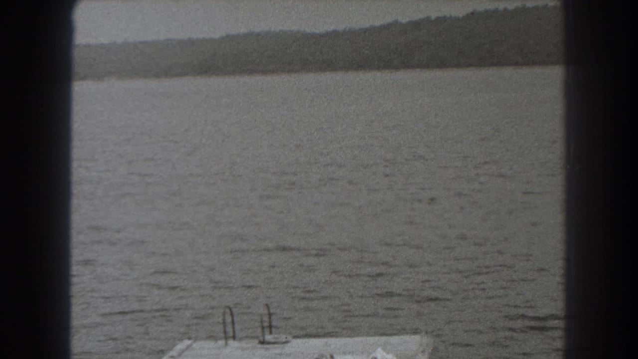 1938 New Jersey lake view with wooded shore in the distance and part of a dock entering the lower frame.