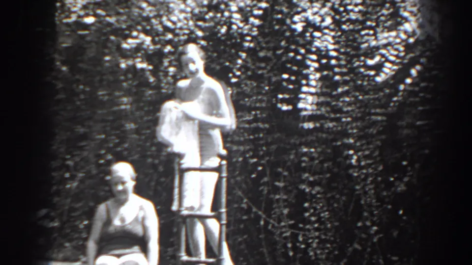 1938 New Jersey frame with a standing woman holding a towel at a metal ladder and a seated woman below.