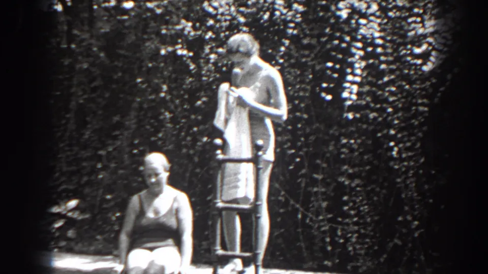 1938 New Jersey 8mm frame showing a woman in swimwear drying beside a ladder with another woman seated in front.