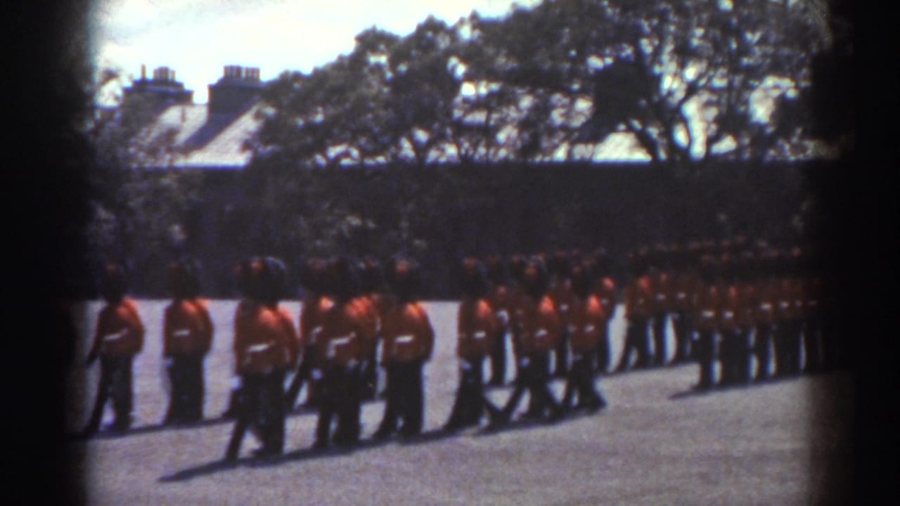 Uniformed men in red tunics march or stand in formation on a paved courtyard.
