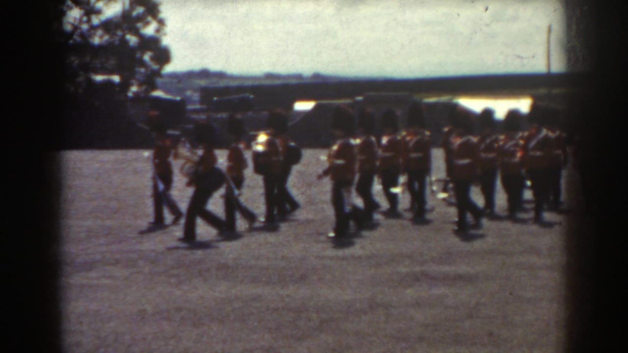 1938 Quebec frame showing guard band members marching in a curve across a sunlit open courtyard.