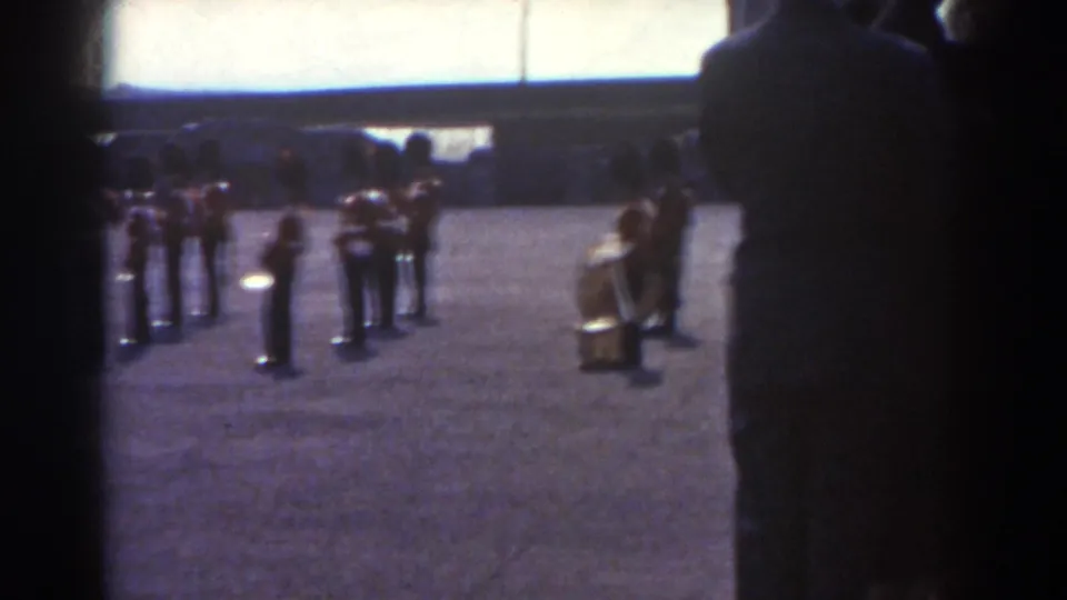 Final 1938 Quebec frame showing several uniformed band members and a drum, partially obscured by dark foreground framing.