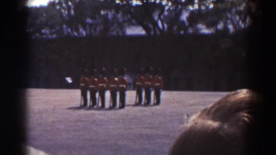 In the Quebec 1938 footage, two groups of ceremonial guards stand at attention while the camera frames them past spectators' heads.