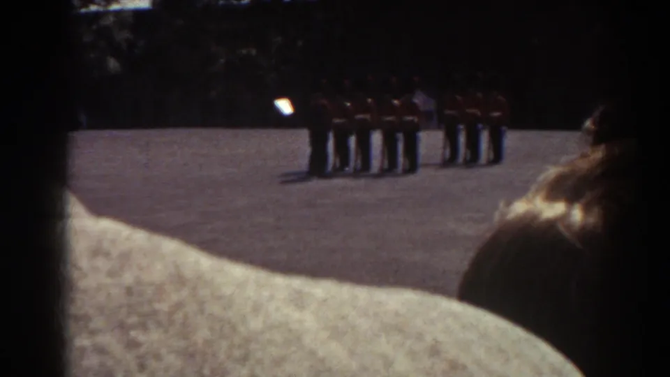 1938 Quebec 8mm view of a military line under sun, with civilian spectators obscuring part of the frame.
