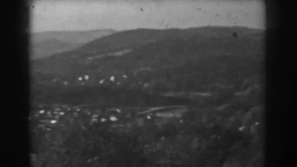 1938 8mm view near Vineland, New Jersey, looking over a valley, tree-covered hills, and small distant houses.