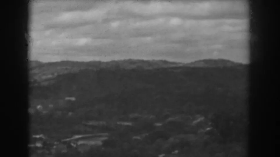 1938 Vineland, New Jersey frame showing a distant hillside settlement, road curve, and overcast sky.