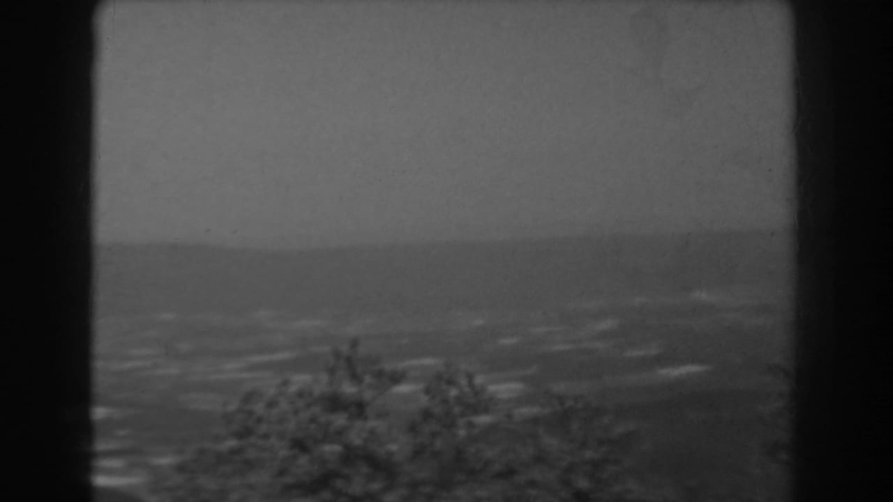 West Virginia home-movie frame from 1938 with a soft, distant valley view bordered by dark window framing.