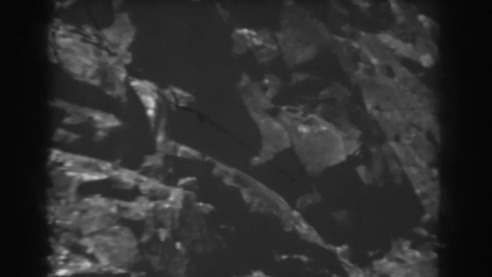 1938 West Virginia frame showing clustered rocks, brush, and heavy 8mm grain near the end of the clip.