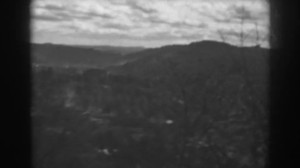 Final sampled frame from the 1938 Winchester, Maryland 8mm clip, with rolling hills, bare or sparse trees, and a cloudy dusk sky.