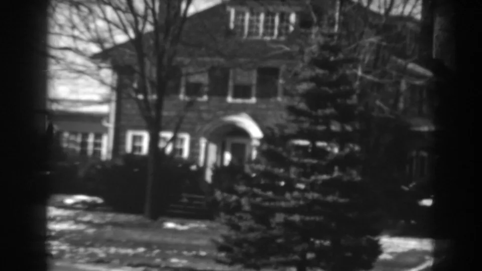 The final frame shows the Winchester brick house exterior with a prominent evergreen, arched entry, winter branches, and patchy snow.