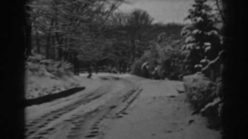 The final frame shows the snow-covered road, tire tracks, trees, and shrubs in the Winchester, Maryland winter landscape.
