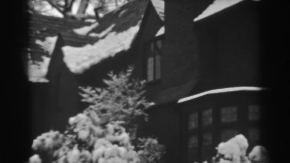 The final frame shows a dark residential facade with windows, roof snow, and bright shrubs in Winchester, Maryland, 1938.