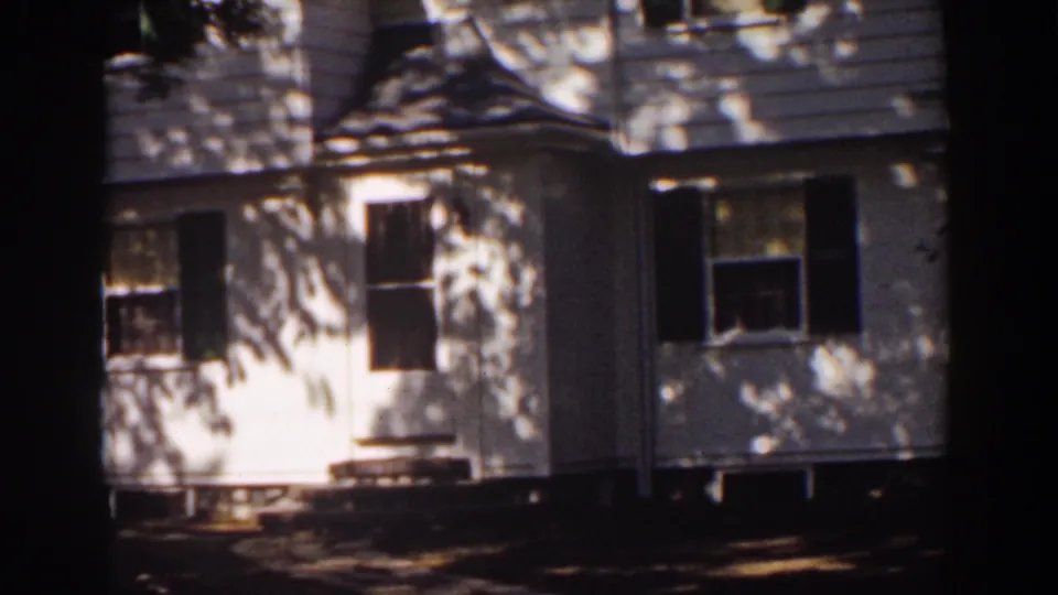 The final frame shows the Mount Washington house exterior, with clapboard siding, shuttered windows, entry steps, and dappled shadows across the wall.